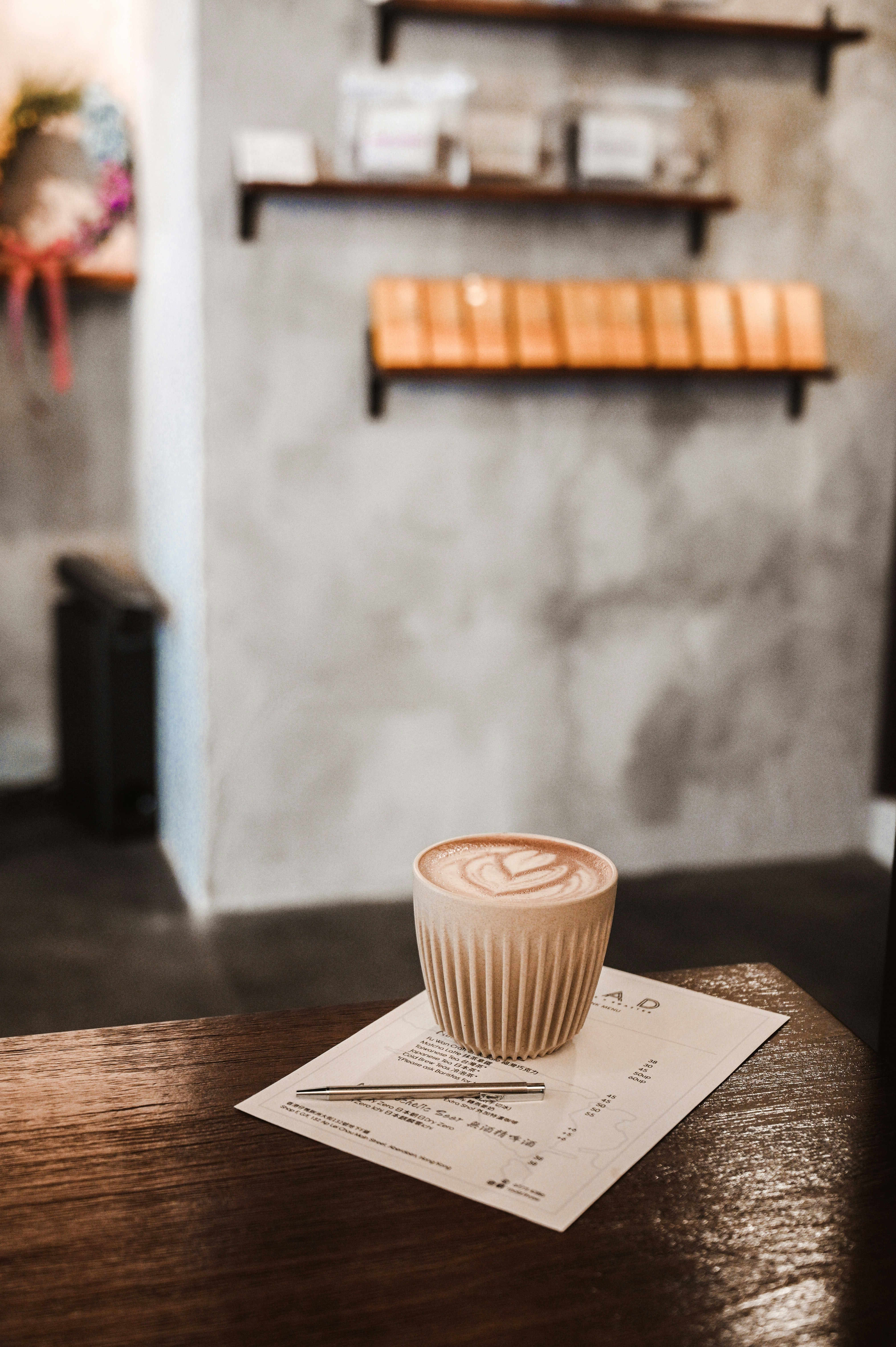 white ceramic cup on white paper